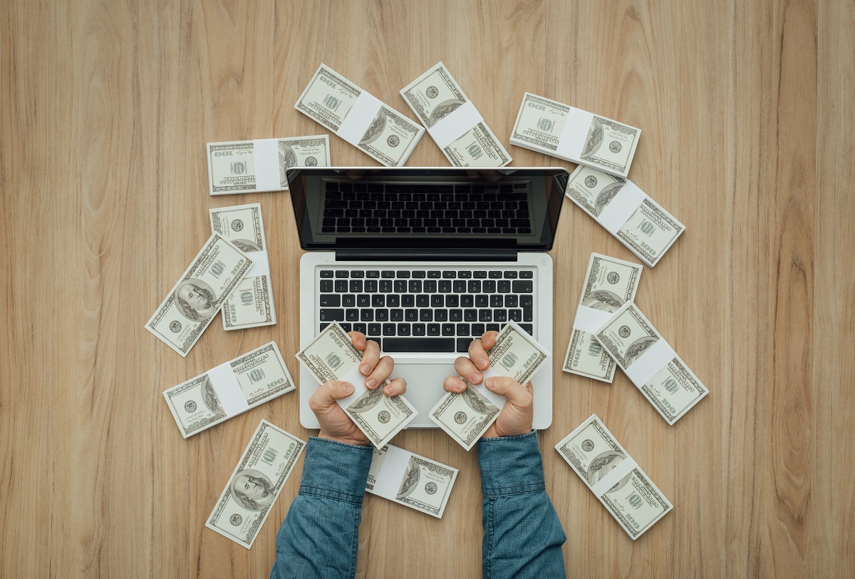 Person holding stashes of money
