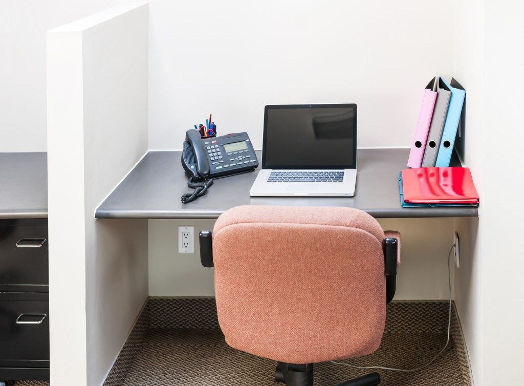small office cubicle with pink chair