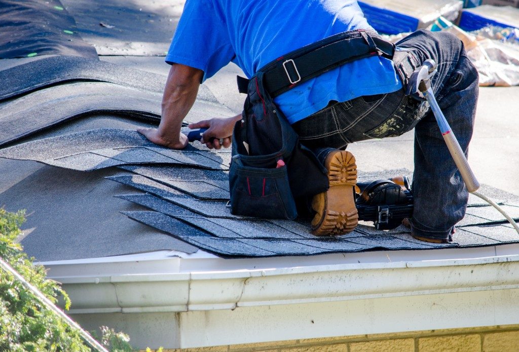 man repairing his roof