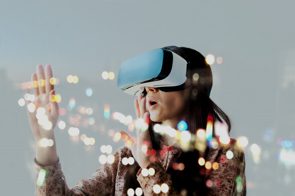 A woman wearing VR goggles and getting immersed