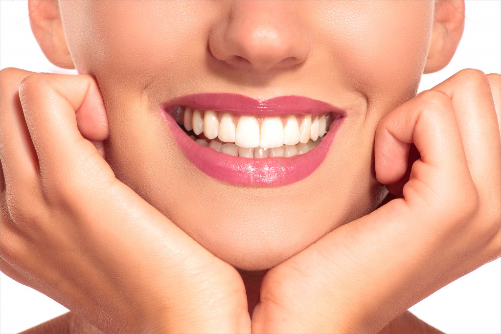 a lady smiling with her perfect white teeth