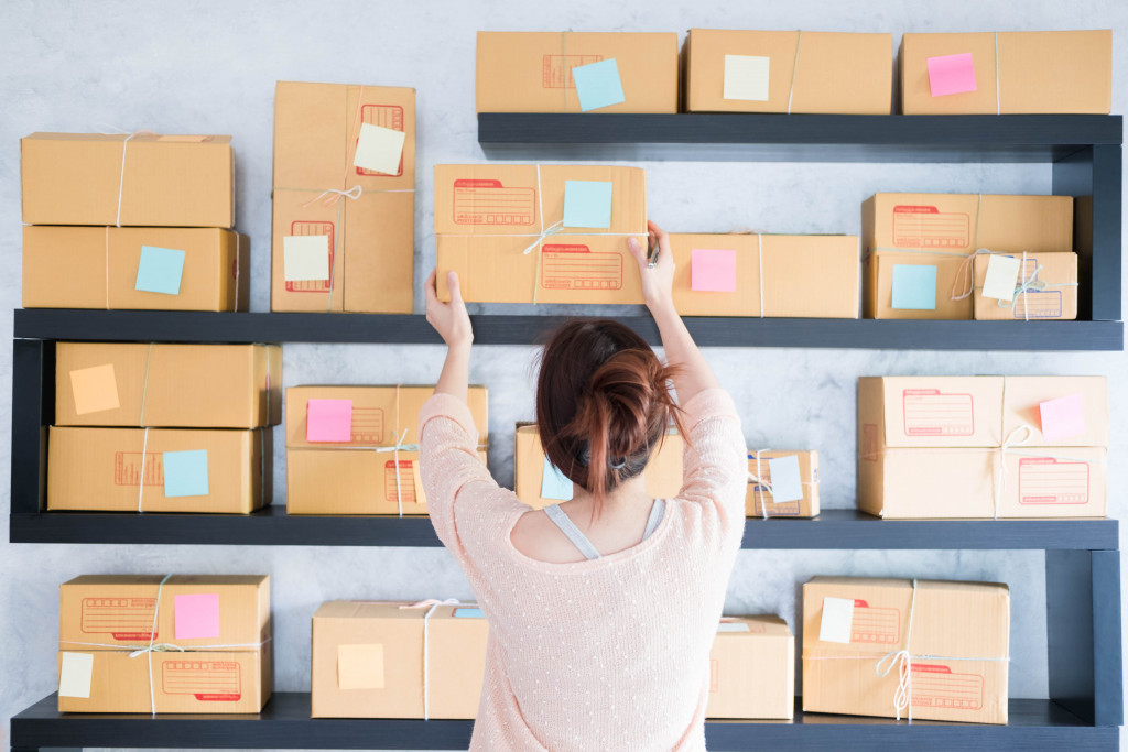 a woman arranging boxes and packages