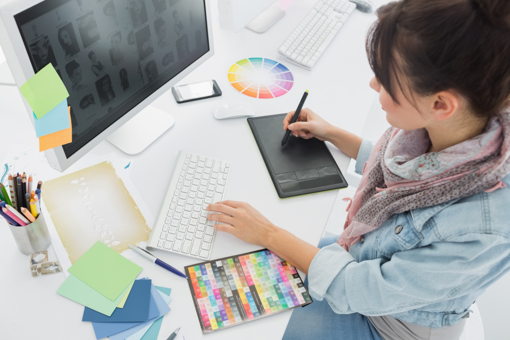 female artist using a drawing tablet on her computer