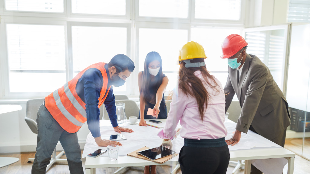 team of builders and architects discussing construction plans in an office