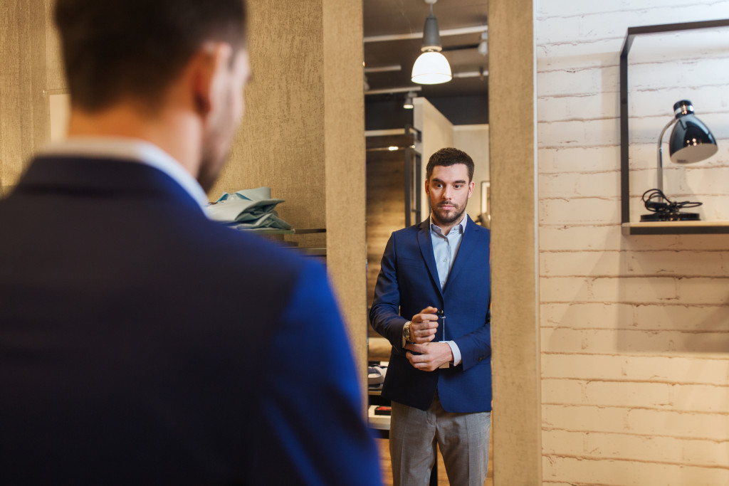 entrepreneur well dressed looking at self in the mirror