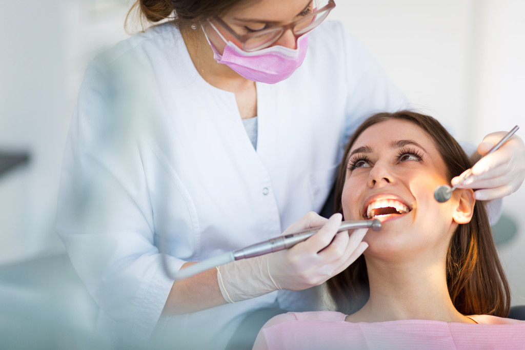 dentist checking patients oral health