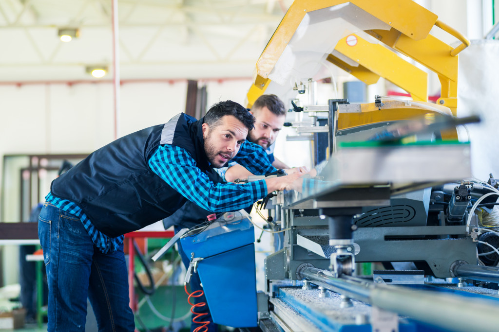 two man looking at the machine