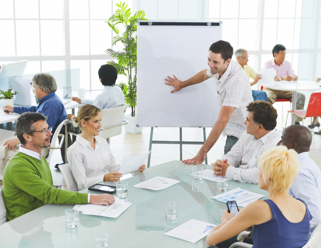 Employees attending a meeting in a diverse workplace.