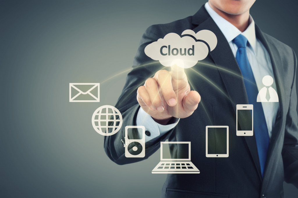 businessman clicking cloud computing