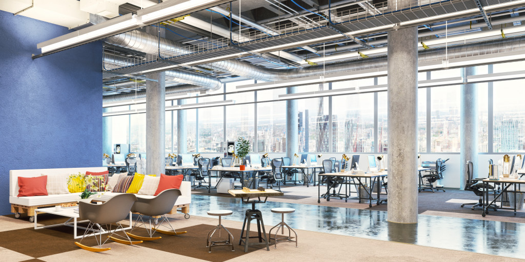 Clean office with chairs, tables, and large windows.