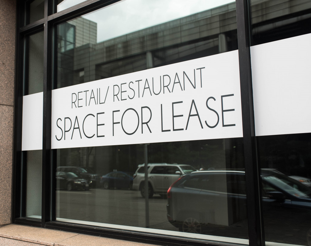 Space for lease sign on the glass window of a commercial space.