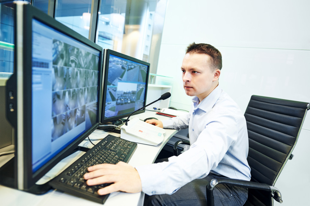 Person monitoring a commercial rental property in an office.