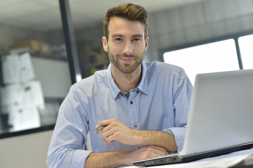 man in office working on laptop