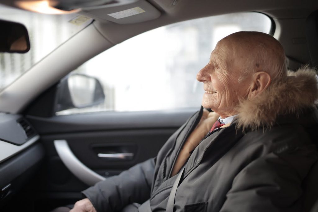elder person riding a car
