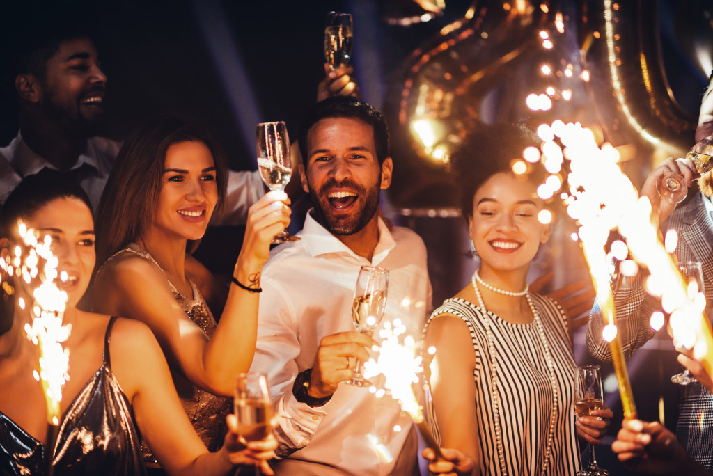 a group of people toasting their drinks and enjoying a local event