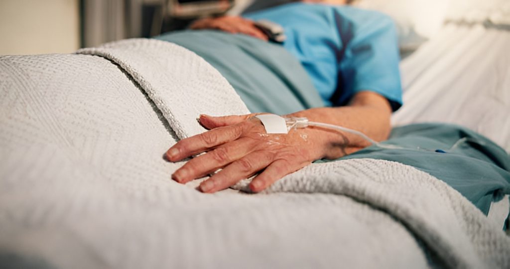 elderly man lying on a hospital bed