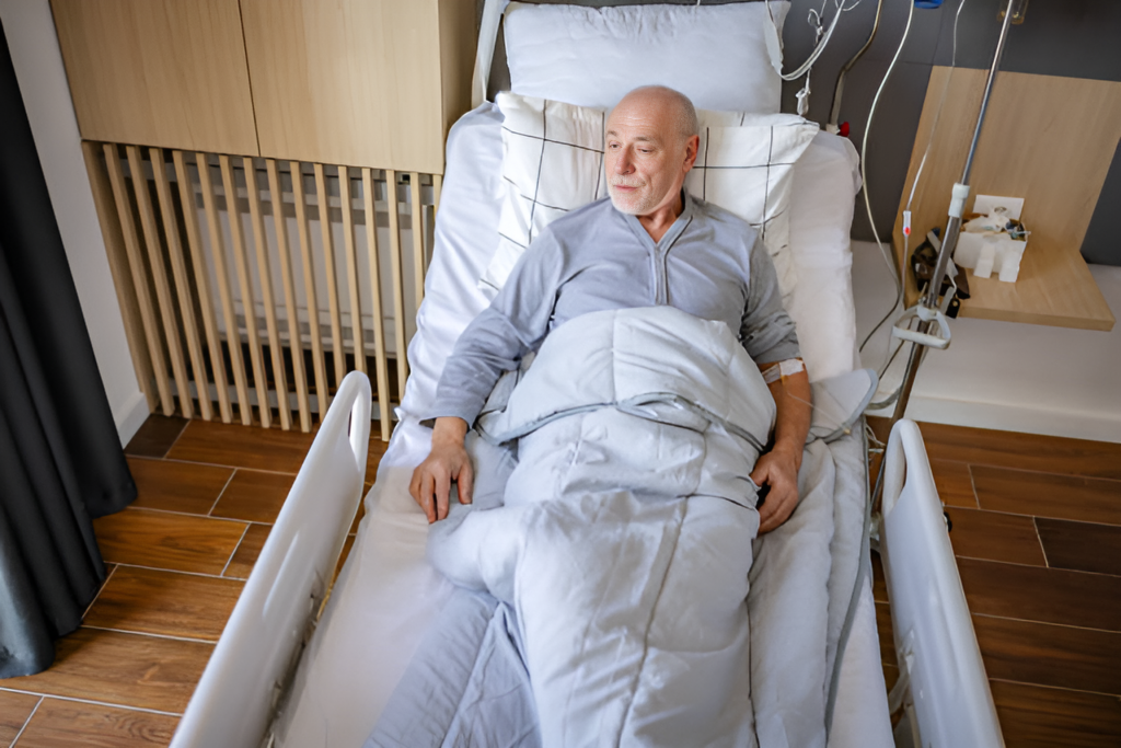 sick elderly man lying on a hospital bed, looking out a window