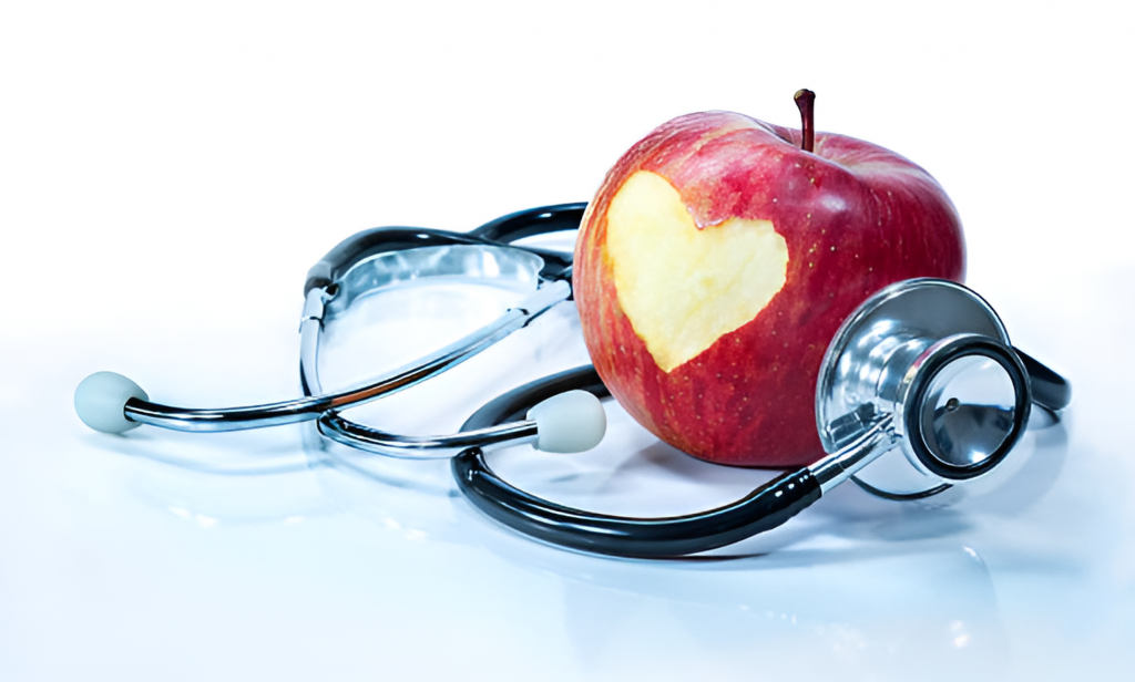 heart carved into an apple and stethoscope
