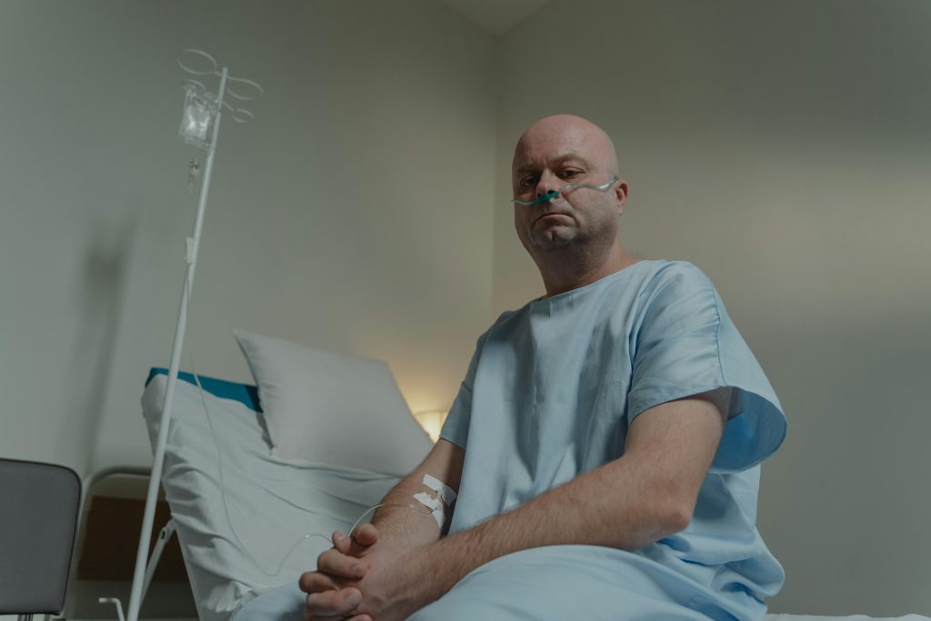 man sitting on a hospital bed
